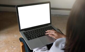 young woman working with laptop computer at home, empty screen display photo