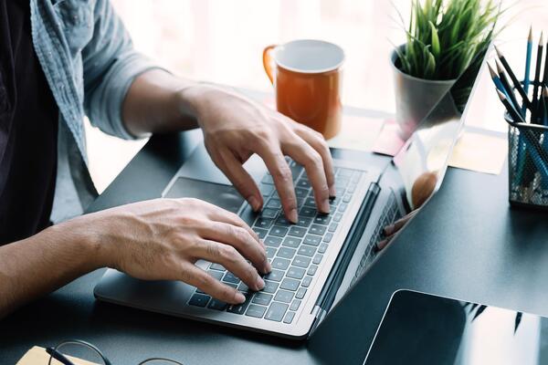 Close up businessman using laptop computer at home