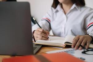 Student using computer laptop for training online and writing lecture note. e-learning education concept photo