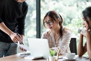 Business Asian people team discussing working analyzing with financial data and marketing growth report graph in team, presentation and brainstorming to strategy planning making profit of company photo