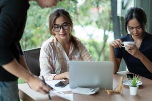 Business Asian people team discussing working analyzing with financial data and marketing growth report graph in team, presentation and brainstorming to strategy planning making profit of company. photo