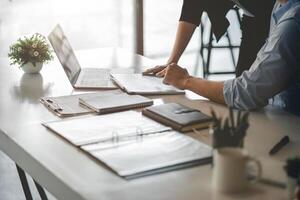 Business People Talking Discussing with coworker planning analyzing financial document data charts and graphs in Meeting and successful teamwork Concept photo