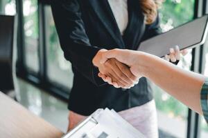 two businessman shake hands as hello in office closeup. Friend welcome, introduction, greet or thanks gesture, product advertisement, partnership approval, strike a bargain on deal concept photo
