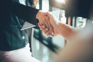 two businessman shake hands as hello in office closeup. Friend welcome, introduction, greet or thanks gesture, product advertisement, partnership approval, strike a bargain on deal concept photo