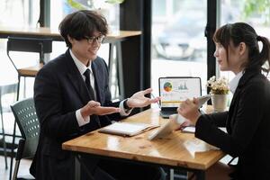 business people discussing the charts and graphs showing the results of their successful teamwork. photo