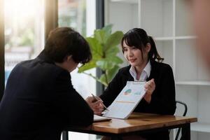 business people discussing the charts and graphs showing the results of their successful teamwork. photo