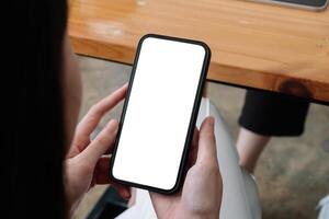 Mock up phone in woman hand showing white screen, female using mobile phone with blank screen for texting, chat. photo