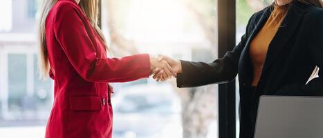 two businessman shake hands as hello in office closeup. Friend welcome, introduction, greet or thanks gesture, product advertisement, partnership approval, strike a bargain on deal concept photo