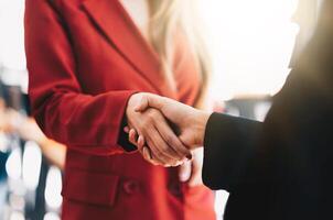 two businessman shake hands as hello in office closeup. Friend welcome, introduction, greet or thanks gesture, product advertisement, partnership approval, strike a bargain on deal concept photo