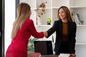 Estate agent and customer shaking hands after finished contract after about home insurance and investment loan photo