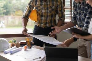 Group of engineer and architect working in office with blueprints, inspection in workplace for architectural plan, construction project, Business construction. photo