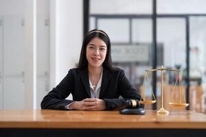 Portrait confidence asian lawyer looking on camera sitting at work desk in office. photo