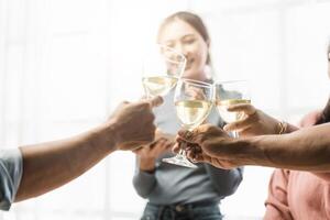 Group of happy colleagues having fun at a new year celebration or business success. Coworkers with diverse people at the office party photo