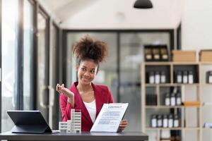Contacting the buying or selling of real estate through a sales representative offering a contract to buy a house or apartment, condo and providing house keys for success photo