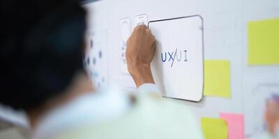 Close up ux developer and ui designer use augmented reality brainstorming about mobile app interface wireframe design on desk at modern office. creative digital development agency photo