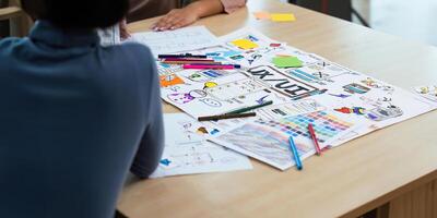 Close up ux developer and ui designer use augmented reality brainstorming about mobile app interface wireframe design on desk at modern office. creative digital development agency photo