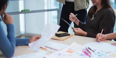 creative digital development agency brainstorming about mobile app interface wireframe design on desk at modern office photo