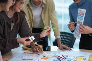 creative digital development agency brainstorming about mobile app interface wireframe design on desk at modern office photo