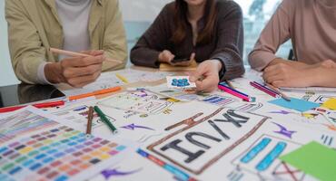 UX developer and ui designer brainstorming about mobile app interface wireframe design at modern office photo