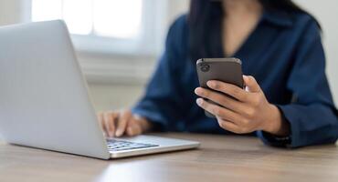 Woman search information from the internet network. Business woman working with smartphone and laptop computer on table in home. network concept photo