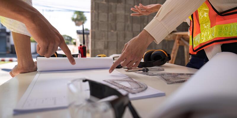Construction concept of Engineer or architect meeting for project working with partner and engineering tools on building and blueprint in working site