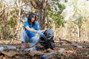Separating waste to freshen the problem of environmental pollution and global warming, plastic waste, care for nature. Volunteer concept carrying garbage bags collecting the garbage photo