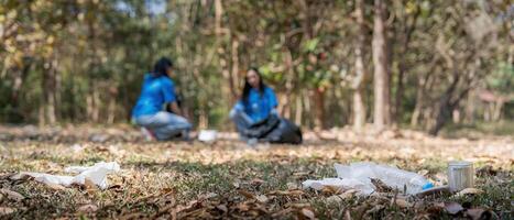 Garbage collect volunteer collect up plastic bottles put garbage at parks avoid pollution be friendly to the environmental and ecosystem photo