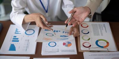 Close up of businesswomen discussing data charts. Concept of teamwork and analysis photo