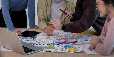 Creative UX Developer and UI Designer Team Brainstorming Session with Digital Devices and Design Sketches for Innovative User Experience Solutions photo
