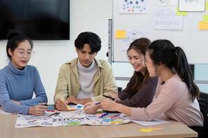 Creative UX Developer and UI Designer Team Brainstorming Session in Modern Office with Colorful Sticky Notes and Diagrams photo