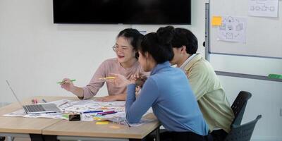 Creative UX Developer and UI Designer Team Brainstorming Ideas in Modern Office Setting with Laptops and Sketches photo