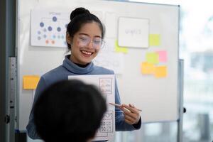 Creative UX Developer and UI Designer Brainstorming Session with Wireframes and Flowcharts on Whiteboard in Modern Office photo