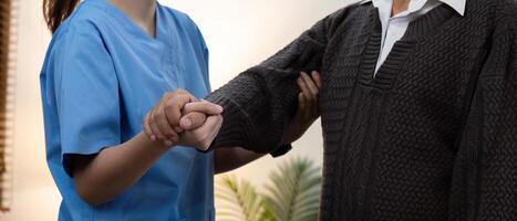 Caregiver Assisting Elderly Patient with Physical Therapy Exercise at Home for Improved Mobility and Health photo