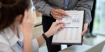 Business Team Analyze Data and discuss strategy in a Modern Office Environment with Charts and Graphs photo