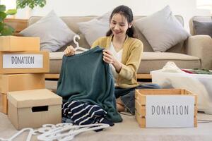 Volunteer Sorting and Donation Clothes for Charity - Community Service and Generosity in Action, Helping Those in Need with Clothing Donations, Social Responsibility and Kindness photo