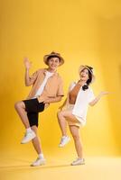 Portrait image of couple posing on yellow background, summer, travel photo