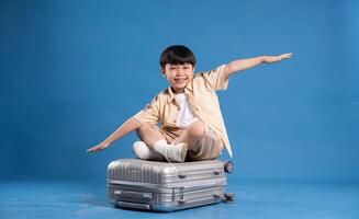 Portrait of asian boy posing on blue background photo