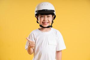 Portrait of adorable asian boy posing on yellow background photo