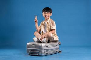 Portrait of asian boy posing on blue background photo