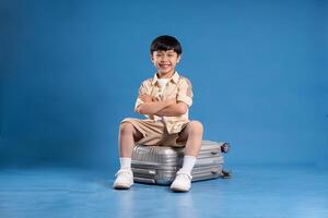 Portrait of asian boy posing on blue background photo