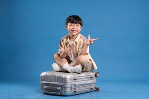 Portrait of asian boy posing on blue background photo