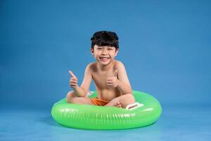 Portrait of asian boy posing on blue background photo