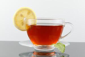 Tea with lemon in a cup. Hot tea with a lemon photo