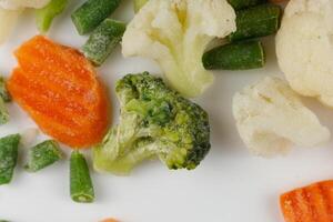 Frozen vegetables close-up on a white background. photo