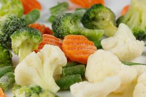 Frozen vegetables close-up on a white background. photo