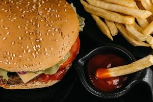 Burger with sauce and French fries. fresh tasty burger photo