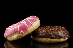 Donuts close-up on a dark background. Delicious pastries. photo