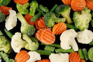 Frozen vegetables close-up on black. photo