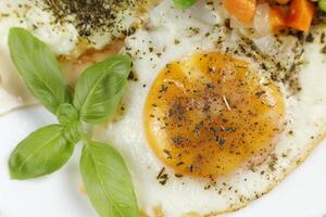 Fried eggs with vegetables. Traditional delicious breakfast and lunch. photo