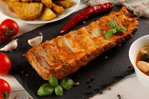 half rack of barbecue pork ribs with fries potatoes photo